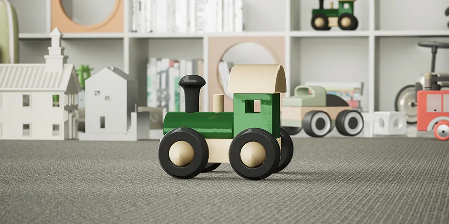 Zelena drvena lokomotiva na podu dečije sobe.